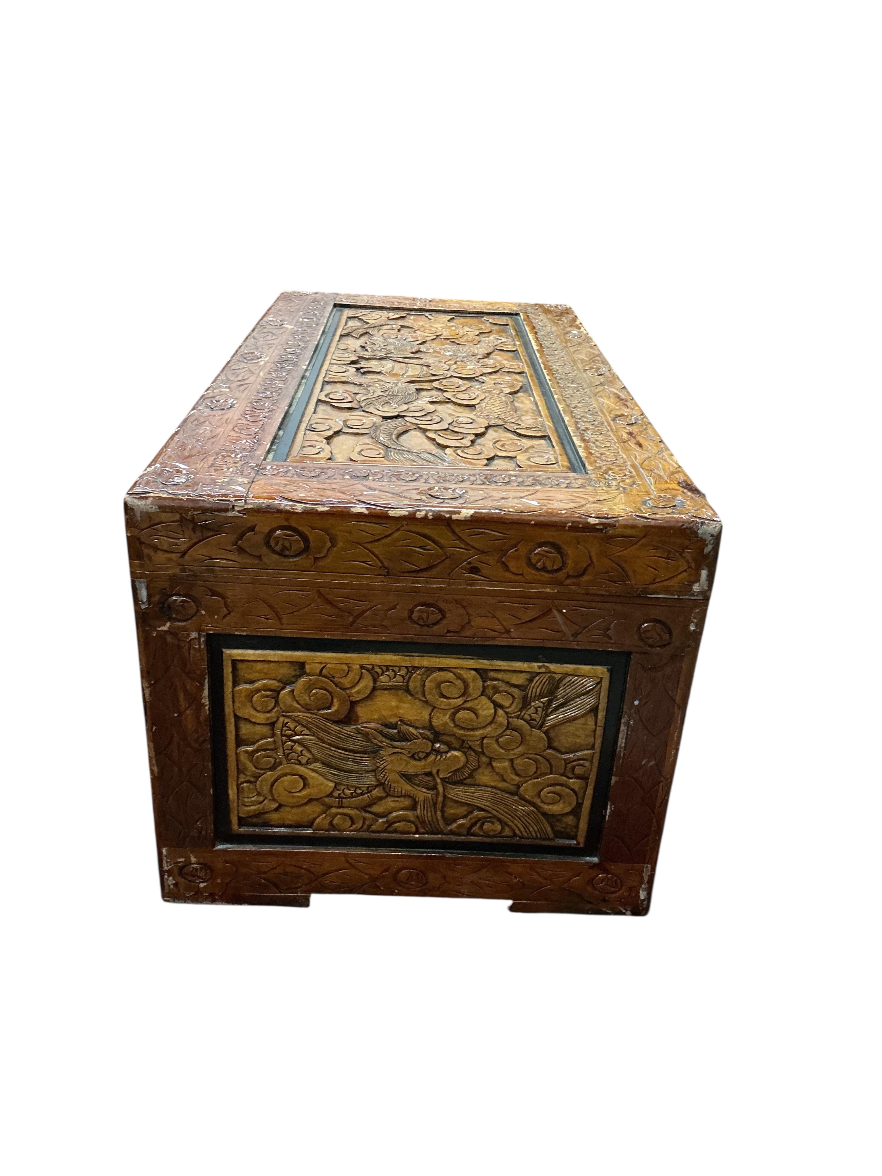 A Chinese carved camphorwood trunk, width 102cm, depth 51cm, height 45cm